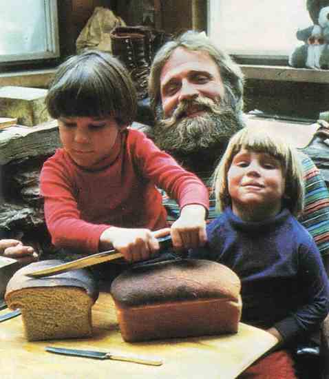
Bob Jordan with sons Seth and Zeke, preparing to enjoy home-baked bread. 
